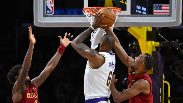 Nov 6, 2022; Los Angeles, California, USA; Cleveland Cavaliers guard Caris LeVert (3) and forward Evan Mobley (4) defend a shot by Los Angeles Lakers forward LeBron James (6) in the first half at Crypto.com Arena. Mandatory Credit: Jayne Kamin-Oncea-USA TODAY Sports